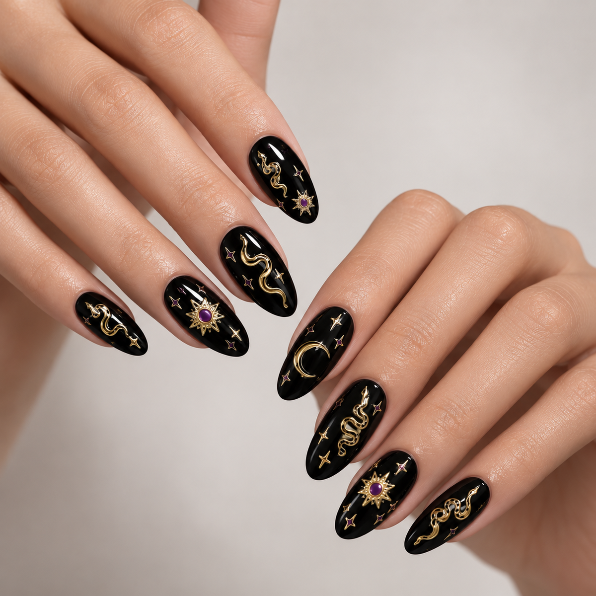 Gold snakes, Stars and Moons by Make Them Gelly, worn on a hand